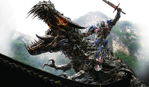 optimus prime autobot sitting on dinobot transformers